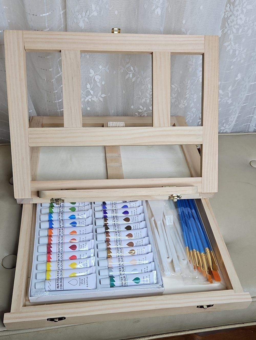 New tabletop wooden art easel box set filled with a vibrant assortment of paint